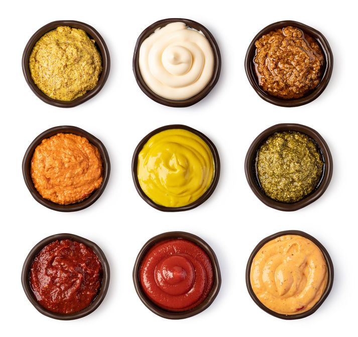 Set of bowls with sauce isolated on white background