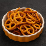 A bowl of crunchy salty pretzels waiting to be snacked on.