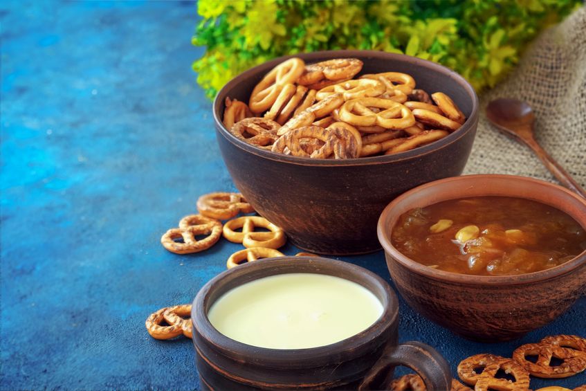 Pretzels in bowl next to dips