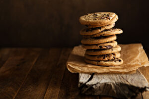Homemade chocolate chip cookies stacked in a rusting setting
