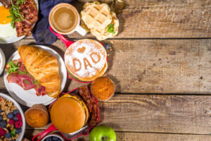 Fathers day Brunch restaurant invitation concept. Various Daddy Man Day Menu background, with traditional breakfast and lunch food set, with tie on sunny wooden background