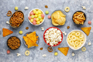 snacks sitting on a table in bowls