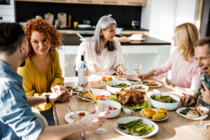 guests talking at thanksgiving dinner table