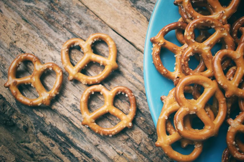 Pretzels on a blue plate and wood table